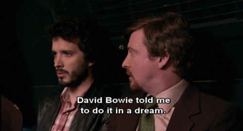 two men sitting next to each other in front of a dark background with the words david bovie told me to do it in a dream  two men sitting next to each other in front of a dark background with the words david bovie told me to do it in a dream