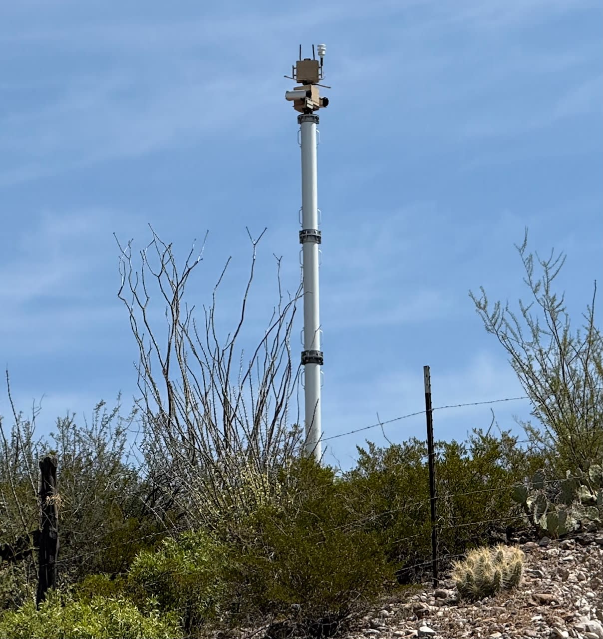 A tall metal tower with a blue sky

AI-generated content may be incorrect.