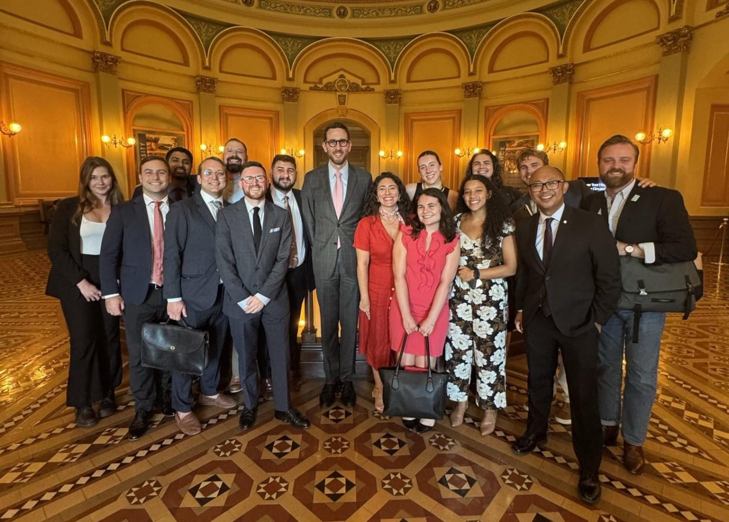 A group of people standing in the rotunda of the California Capitol building—including various co-sponsors, legislative staffers, and Senator Wiener.