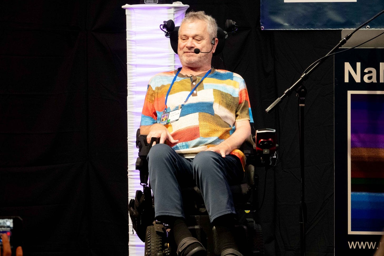 Photo of Dave Warnock on the conference stage.