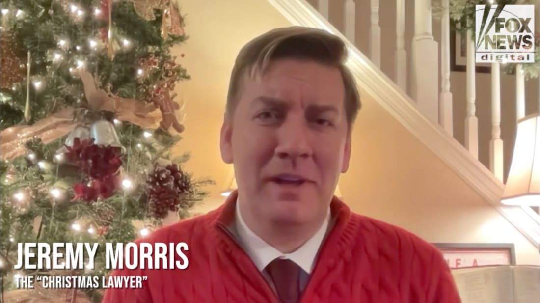Jeremy Morris, known as the Christmas Lawyer, speaks on camera in front of a decorated Christmas tree, wearing a red sweater inside a warmly lit home, with a Fox News Digital logo visible.