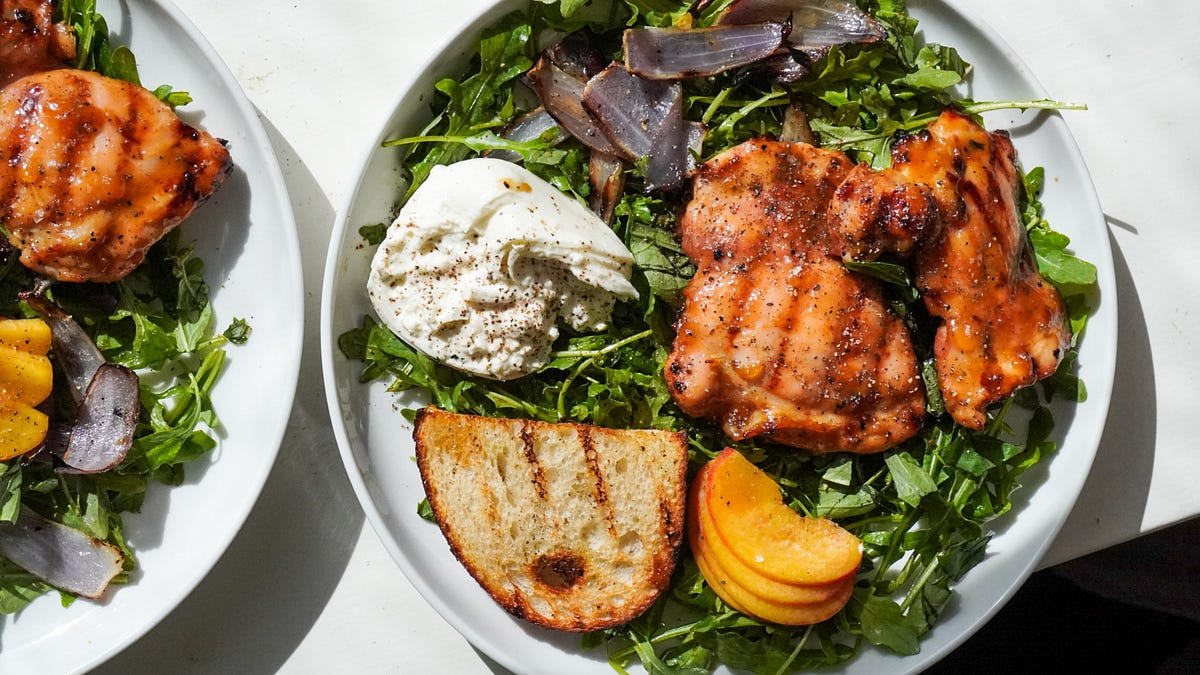 Apricot glazed chicken served with fresh arugula