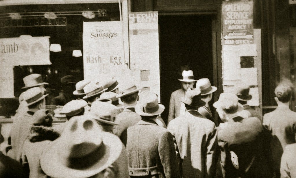 Men seeking employment at a "Splendid Service Employment Agency" on Sixth Avenue, New York, during the Great Depression.