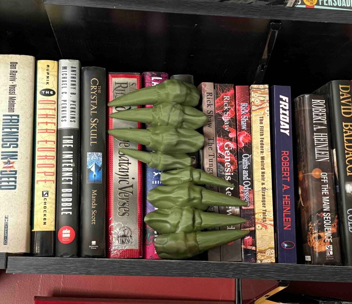image of 3D printed demon claws in a bookshelf image of 3D printed demon claws in a bookshelf