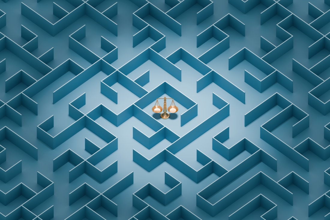 A maze with the scales of justice in the center