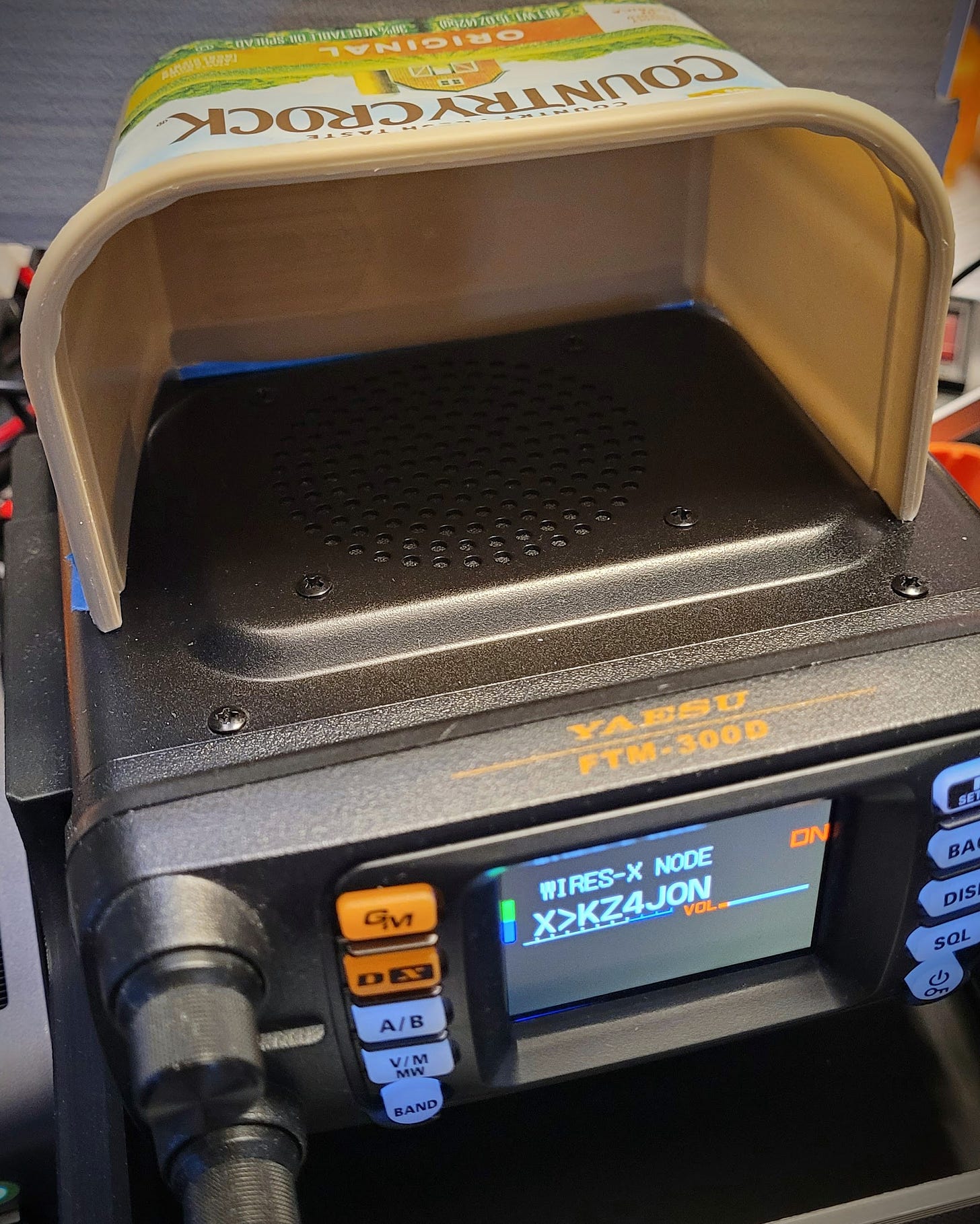 Margarine container to redirect sound from radio speaker