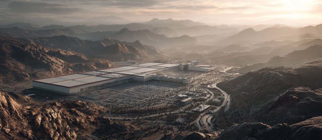 Aerial view of a massive AI data center complex surrounded by power infrastructure in a desert landscape.