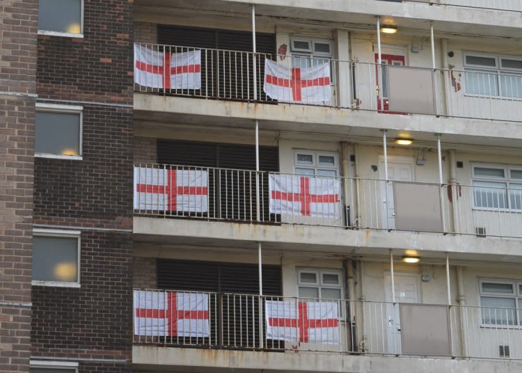 Flats with the St George Cross flags hanging on each balcony by each flat