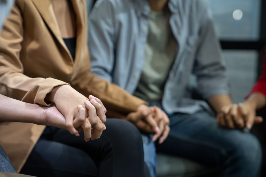 Family members hold hands.