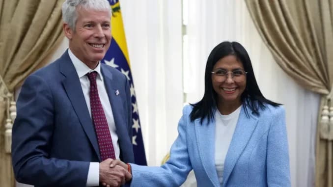 Venezuela's interim President Delcy Rodriguez shakes hands with US Energy Secretary Chris Wright on February 11 Leonardo Fernandez Viloria Reuters
