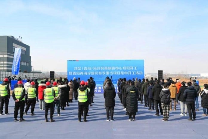 The cleared Xuejiadao site at groundbreaking, with the neighboring shipyard behind it. Source: Weichai Power.