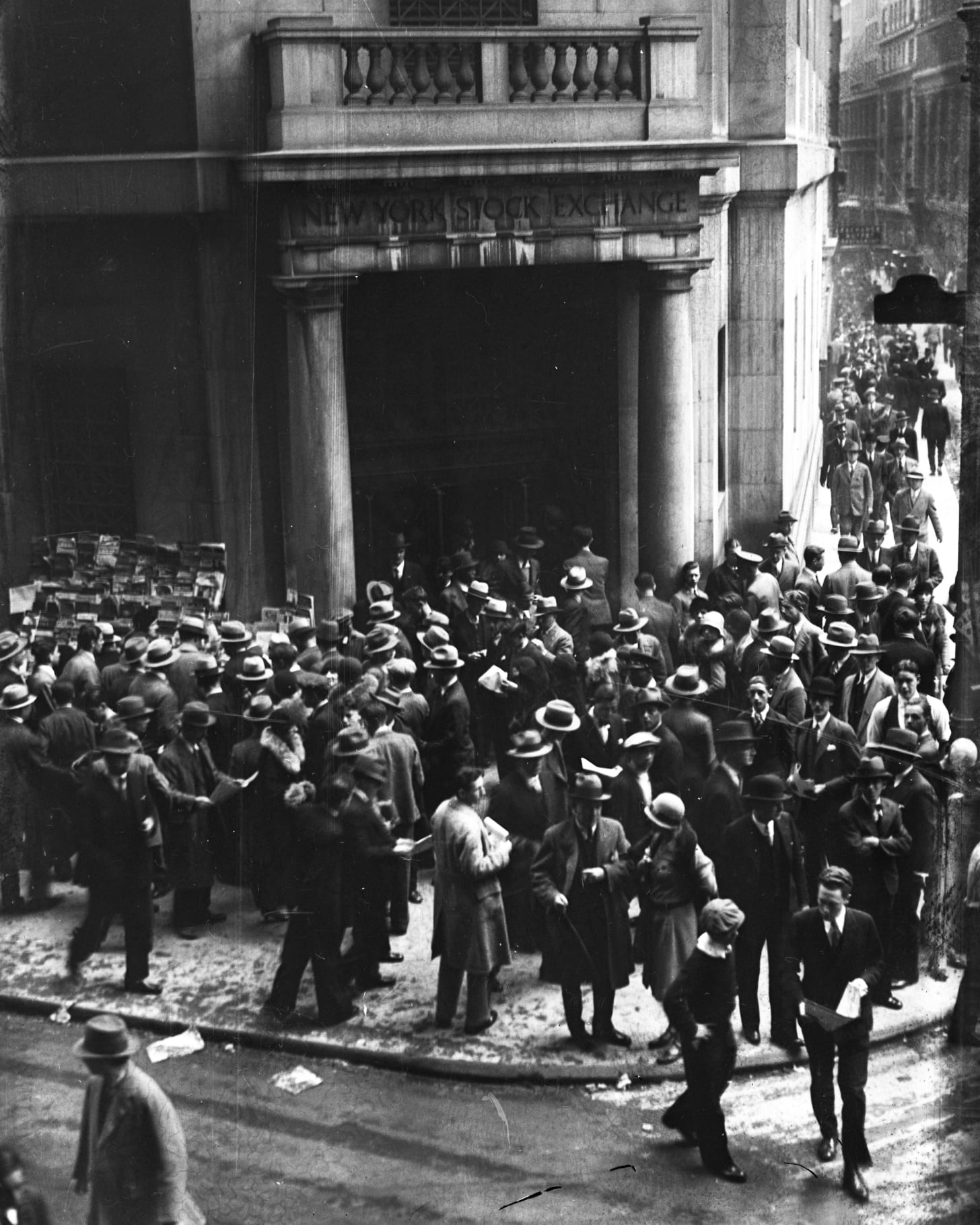 Crowds of people gather outside the New York Stock Exchange on Wall Street after the Stock Market Crash on 1929. The Roaring Twenties, a time of wealth and excess, has been claimed to be the blame of the crash that eventually led to the Great Depression. Crowds of people gather outside the New York Stock Exchange on Wall Street after the Stock Market Crash on 1929. The Roaring Twenties, a time of wealth and excess, has been claimed to be the blame of the crash that eventually led to the Great Depression.