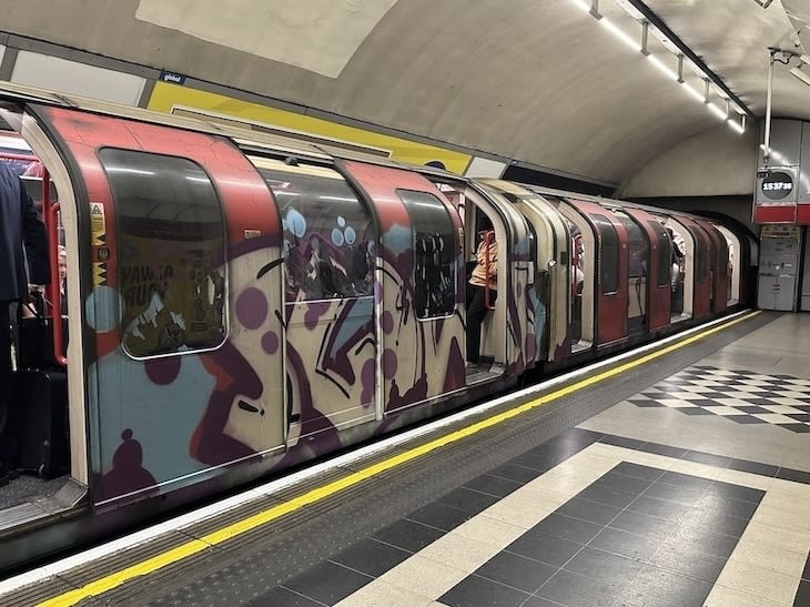 A tube train covered in graffiti