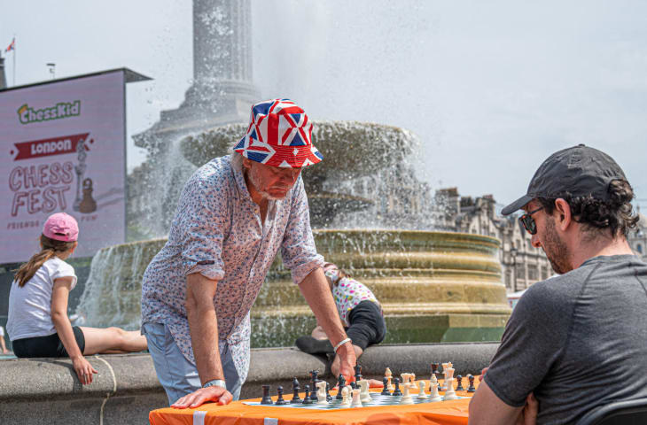 Two men playing chess against each other in front of the Trafalgar Square fountains