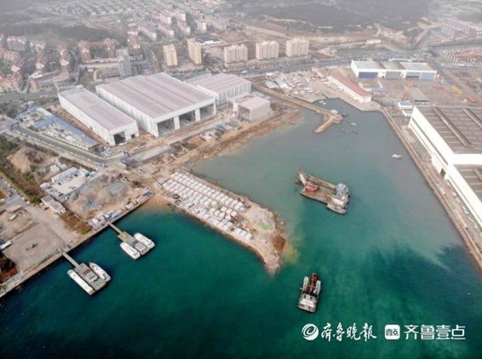 Aerial view of the wharf works with the production halls under construction behind, November 2023. Source: Qingdao News.
