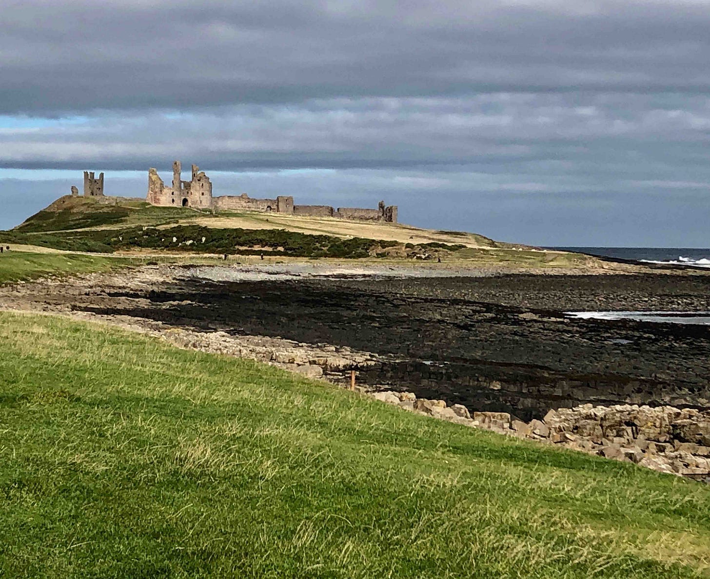 A grass field with a castle on the hill

AI-generated content may be incorrect.