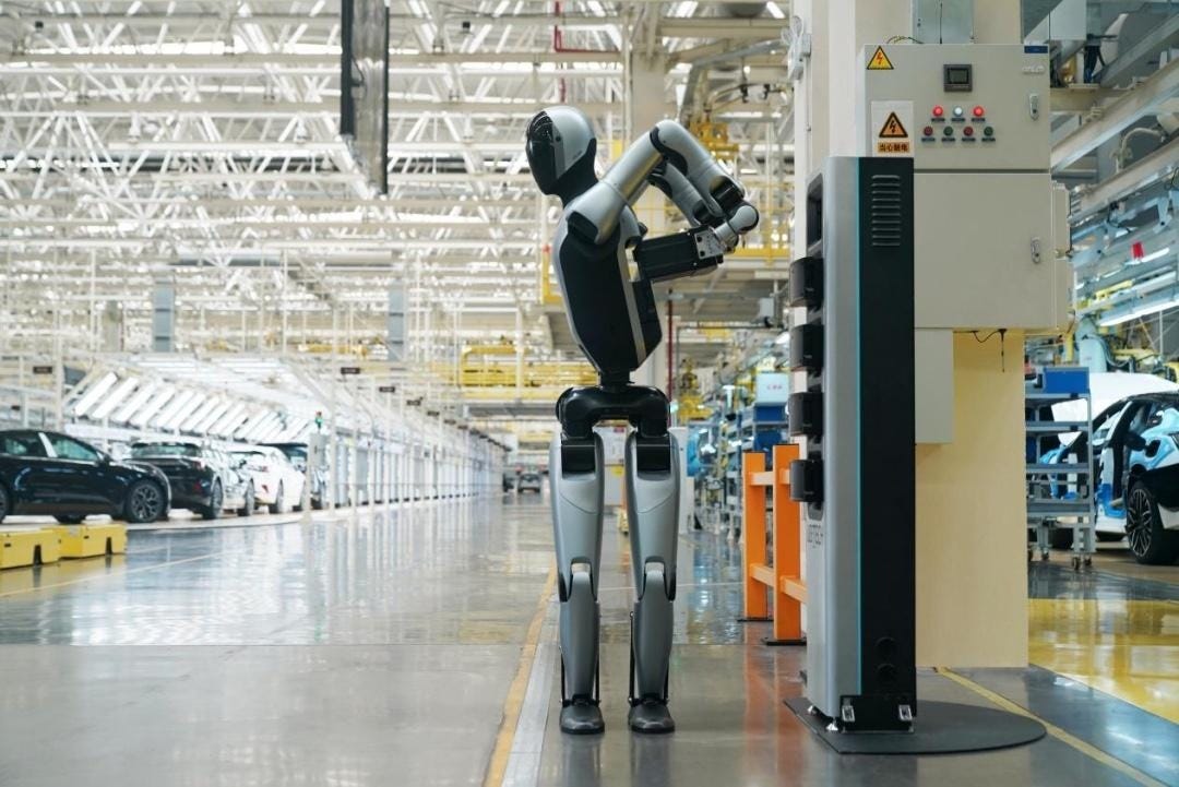 A UBTech Walker S2 swaps its own battery on a car-factory floor.
