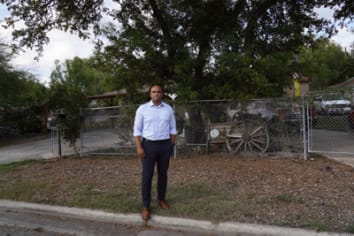 Colin standing in front of a fence