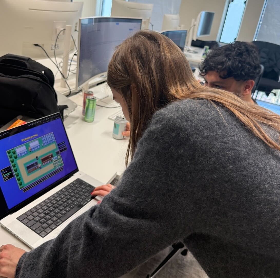 A couple of people looking at the laptop with LennyRPG running.