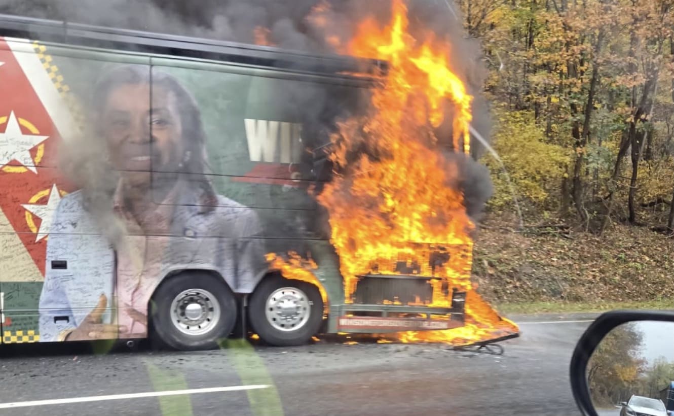 A bus on fire on the road AI-generated content may be incorrect.