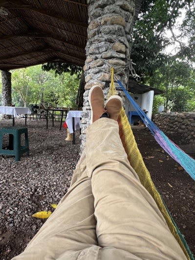 A person's legs and feet on a hammock

AI-generated content may be incorrect.
