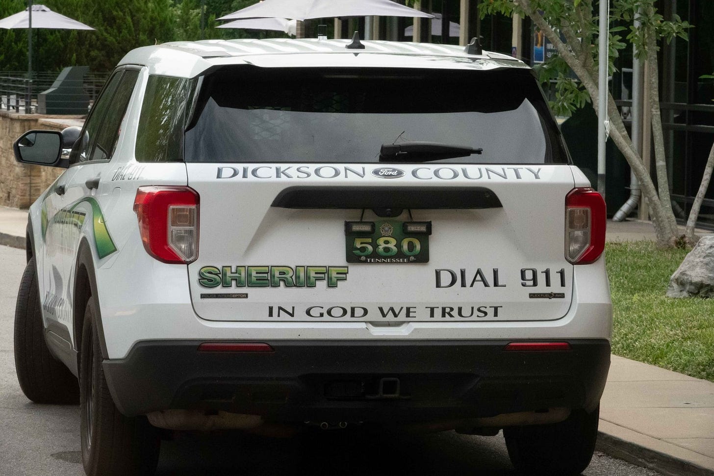 photo of Sheriff's vehicle that says, "In God We Trust" in big bold letters.