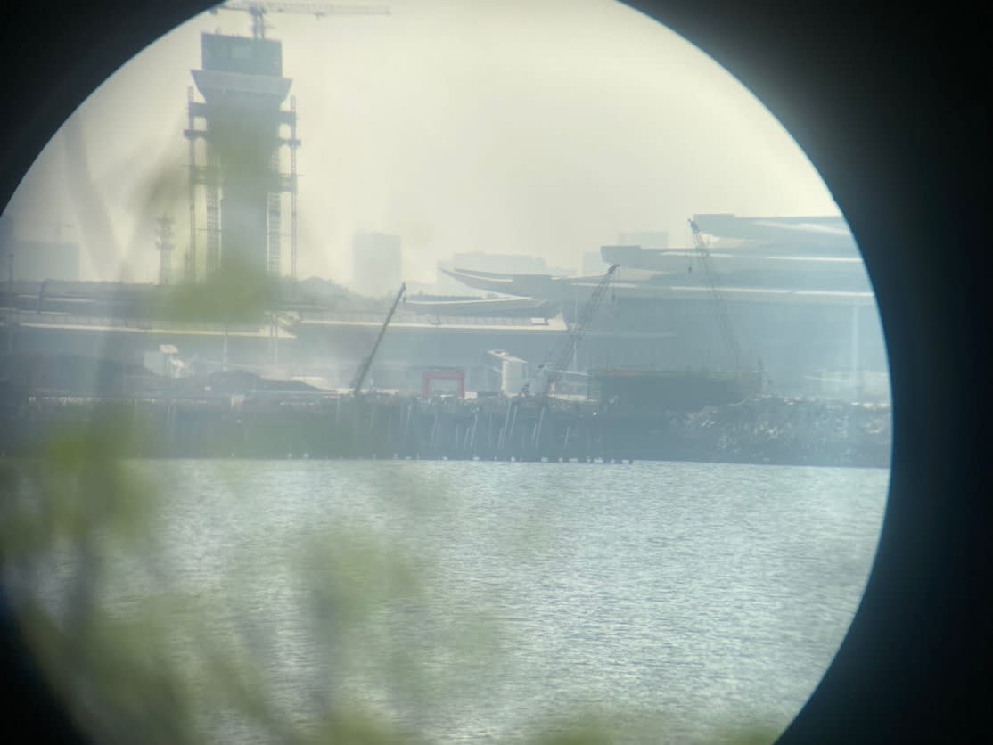 A view through a circular window of a city

AI-generated content may be incorrect.