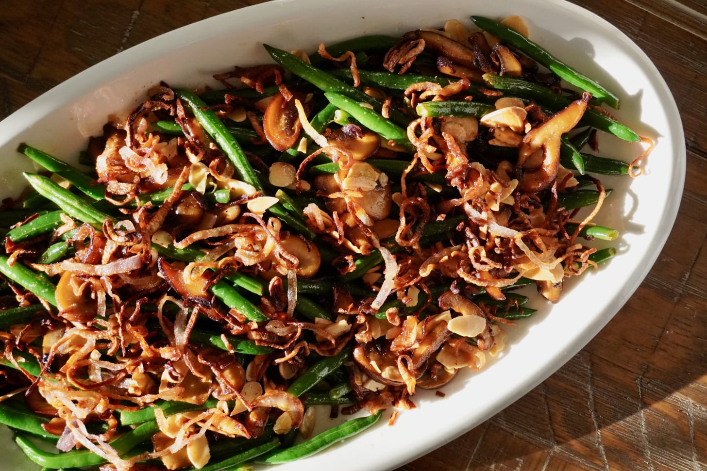 Haricots verts amandine — French-style green beans with toasted almonds, golden mushrooms, and crispy shallots — light and buttery Thanksgiving side dish