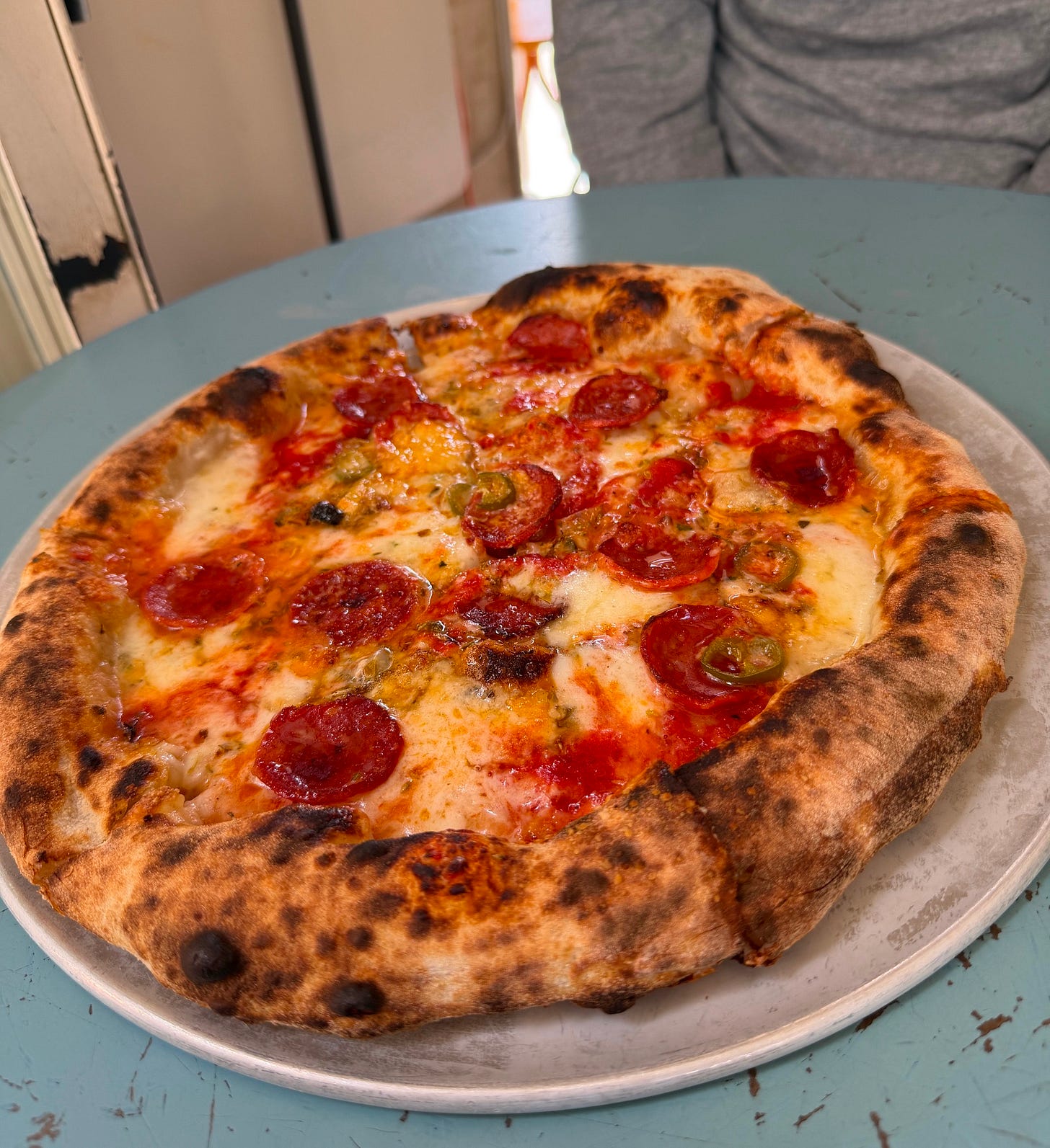 Charred Neapolitan-style pepperoni pizza topped with pickled jalapeños at Lupita restaurant in Lisbon