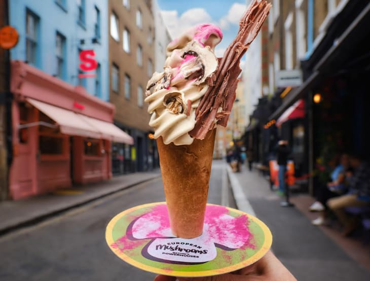 An ice cream in a cone with a chocolate flake
