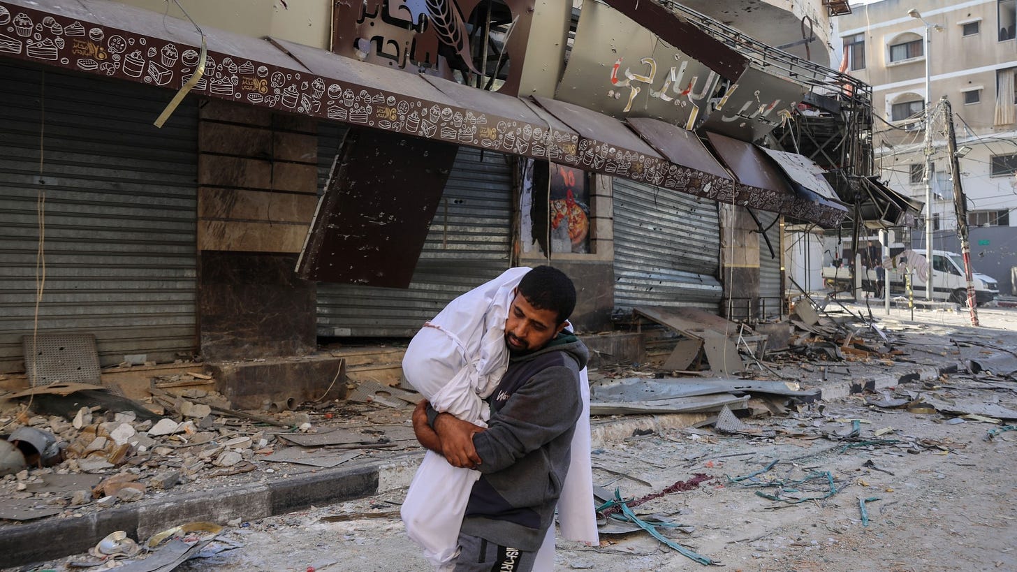A man carrying the coffin of a dead child in Gaza City, on 24 November 20233 (MEE) A man carrying the coffin of a dead child in Gaza City, on 24 November 20233 (MEE)