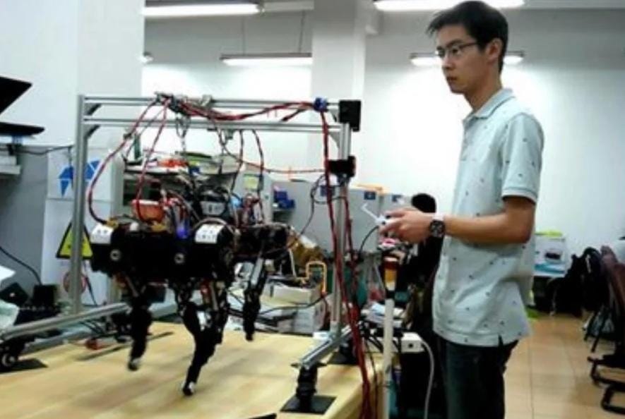 Wang Xingxing with XDog, the electric quadruped he built as a graduate student at Shanghai University.