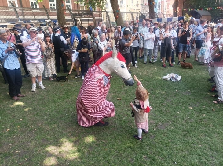 A boy and a person dressed as a horse