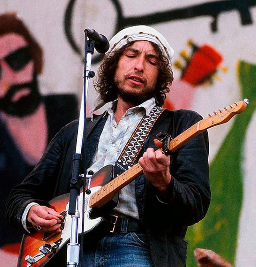 Bob Dylan onstage with an electric guitar during the second Rolling Thunder Revue in 1976.