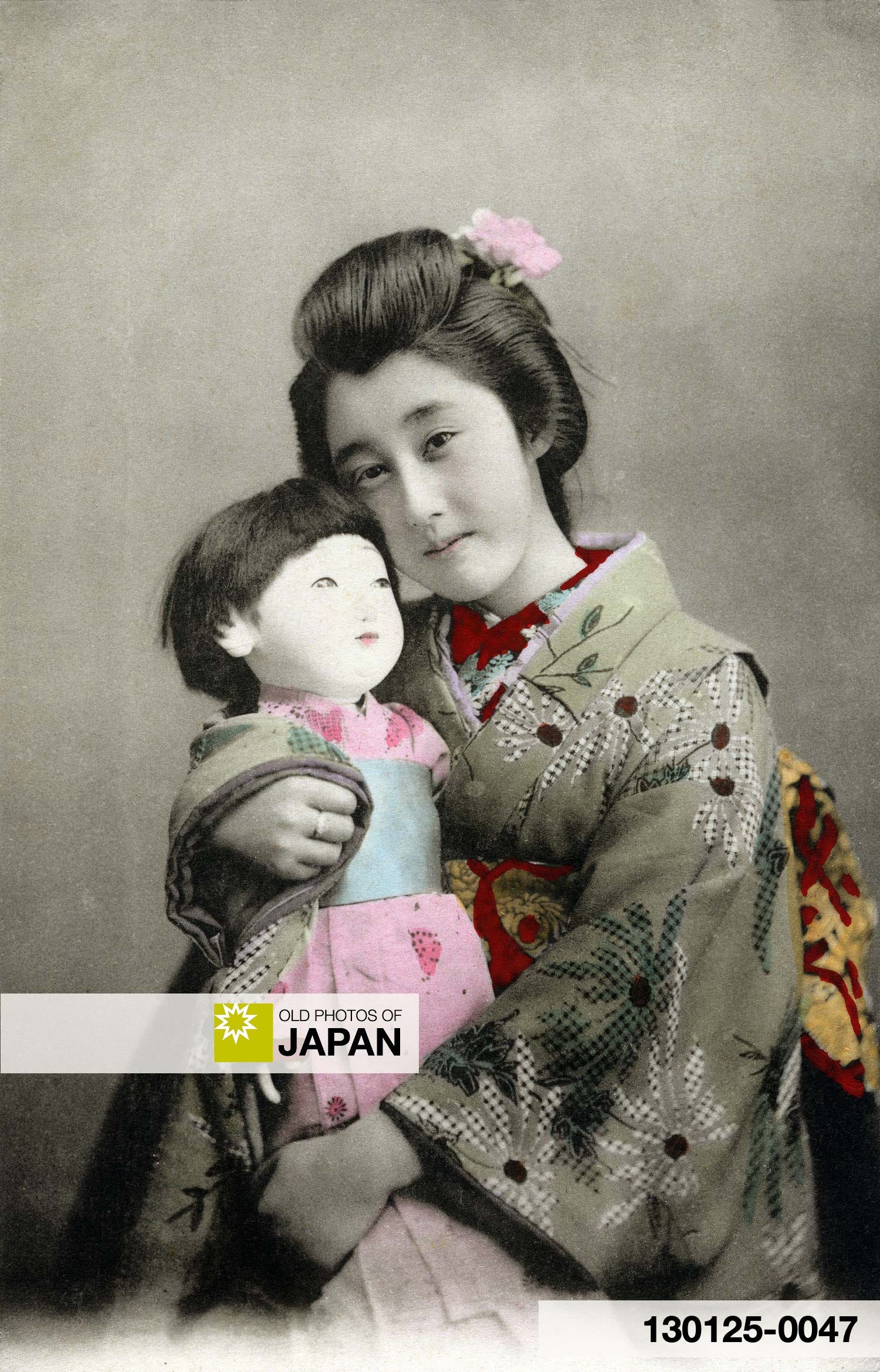 Young Japanese woman with doll, 1900s. 