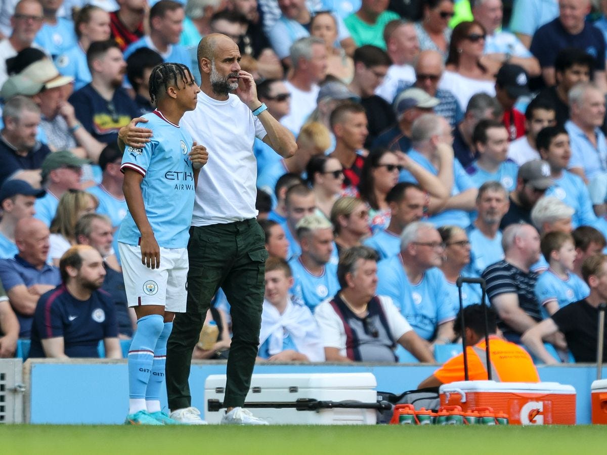 Manchester City's Nathan Aké, left, and Bayern Munich's Thomas Müller go  after the ball during the first half of a friendly soccer match Saturday,  July 23, 2022, at Lambeau Field in Green