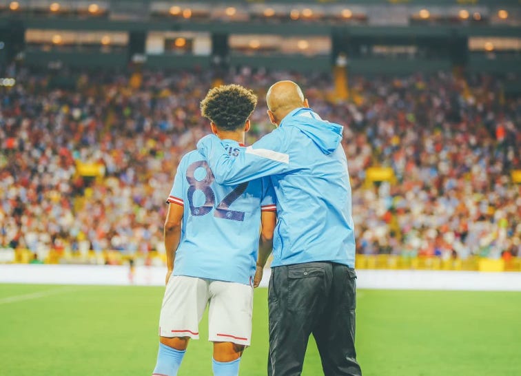 Manchester City's Nathan Aké, left, and Bayern Munich's Thomas Müller go  after the ball during the first half of a friendly soccer match Saturday,  July 23, 2022, at Lambeau Field in Green