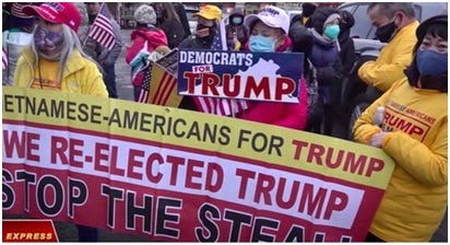 What does the flag with yellow background with three red stripes stand for?  I've seen this in a photo of a Trump rally scheduled for today, December  12, strewn in the crowd