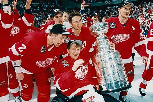 The Detroit Red Wings receiving their Cup with the Star defenseman Vladimir Konstantinov in a wheelchair.