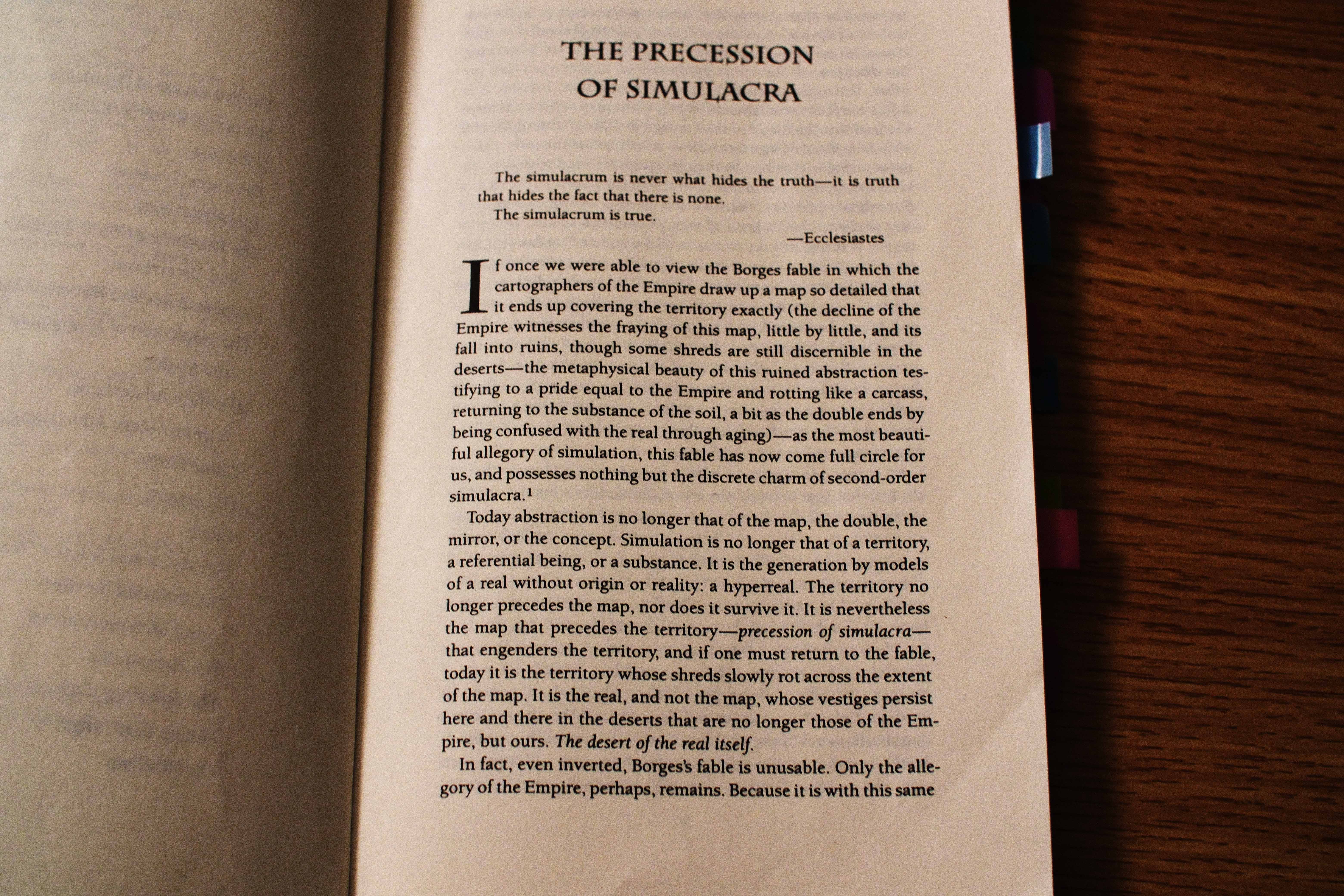 In The Matrix, we all know Neo opens the book Simulacra and Simulation,  which is about how human experience is of a simulation of reality. But he  opens the chapter to On