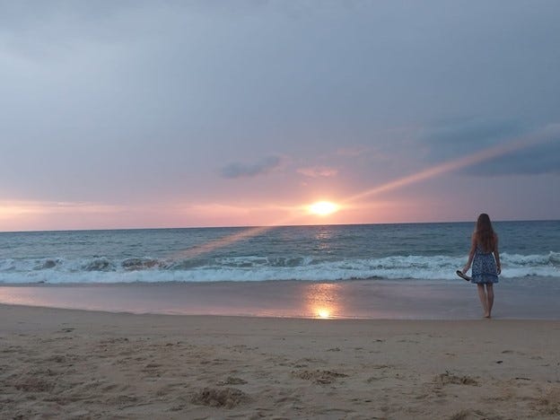 A person standing on a beach

Description automatically generated