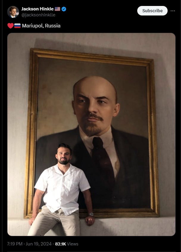 Jackson Hinkle posing in front of Lenin