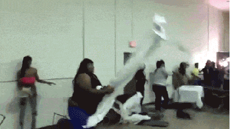 The story behind the GIF of a woman throwing an entire folding table during  a brawl