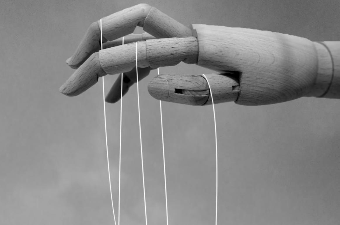 Who are the True Puppet Masters? – Erik Carlson