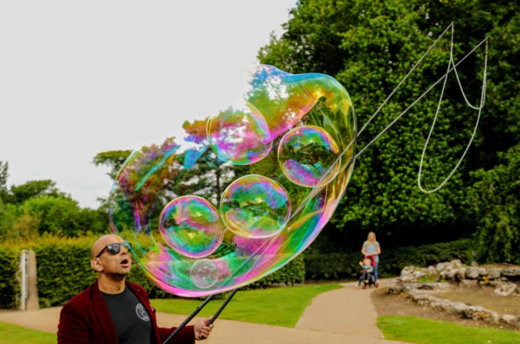 A man blowing huge bubbles