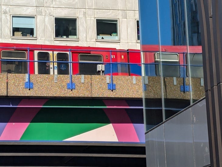 A DLR train reflected in windows