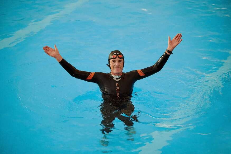 A man in a wetsuit, in a lido