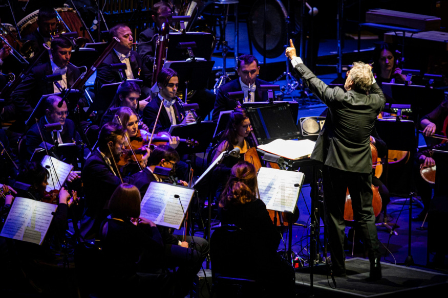 A conductor conducting an orchestra