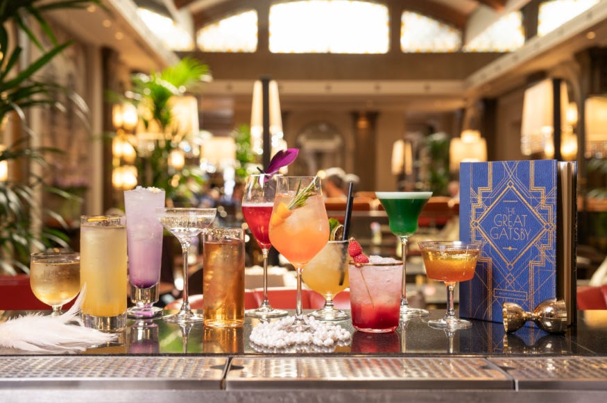 11 varied cocktails alongside a Great Gatsby menu on the bar at Sheraton Grand Park Lane