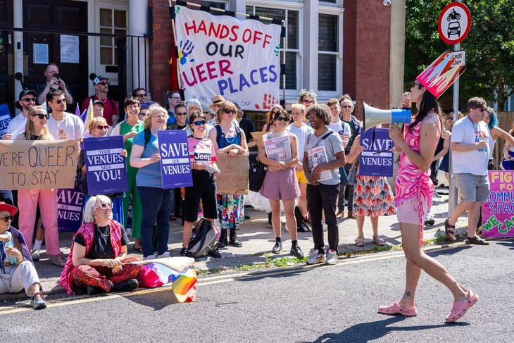 A campaign group holding placards that call for protection for queer spaces